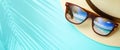 vacation and summer travel banner concept on tropical sea. Panama hat and sunglasses with a reflection of the sandy trovic beach Royalty Free Stock Photo