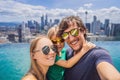 Vacation and technology. Happy family with kid taking selfie together near swimming pool with panoramic views of the Royalty Free Stock Photo