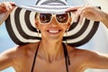 Vacation time! Beautiful summer portrait of pretty woman in hat and sunglasses - close up
