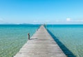 Vacation Time Concept, Wooden Path Between Crystal Clear Blue Sea and Sky from Beach of Island to The Pier in Thailand Royalty Free Stock Photo