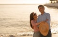Vacation Time. Romantic mature couple relaxing together on the beach in sunset Royalty Free Stock Photo