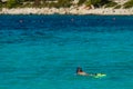 Vacation tourist, young person, snorkeling in paradise clear water. Snorkeler in crystalline waters . Turquoise sea background