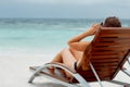 Vacation. Travel. Beautiful young woman relaxing on beach chair Royalty Free Stock Photo