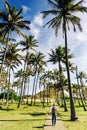 Happy hipster gitl walking bitween palm trees on Anakena beach, Easter Island Royalty Free Stock Photo