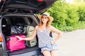 Vacation, Travel concept - young woman ready for the journey on summer holidays with suitcases and car Royalty Free Stock Photo