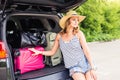 Vacation, Travel concept - young woman ready for the journey on summer holidays with suitcases and car Royalty Free Stock Photo