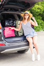 Vacation, Travel concept - young woman ready for the journey on summer holidays with suitcases and car Royalty Free Stock Photo