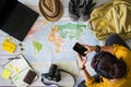 Vacation travel planning concept with map. Overhead view of equipment for travelers. Travel concept background, young Asian woman