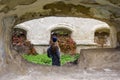 Vacation, travel, tourism in autumn season. Young girl with long blond hair examines the ruins of an ancient building