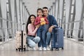 Vacation Trip. Portrait Of Happy Young Arab Family Posing At Airport Terminal Royalty Free Stock Photo