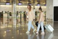 Vacation Trip. Portrait Of Happy Young Family Posing At Airport, mom And Little Daughter With Suitcases At Terminal Royalty Free Stock Photo