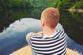 Vacation trip on the river. Handsome man is sitting on the prow of the boat Royalty Free Stock Photo