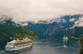 Vacation, trip, wanderlust. Cruise ship in norwegian fjord. Passenger liner docked in port. Travel destination, tourism Royalty Free Stock Photo