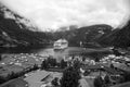 Vacation, trip, wanderlust. Ship in norwegian fjord on cloudy sky. Ocean liner in village harbor. Travel destination Royalty Free Stock Photo