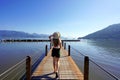 Vacation in Ubatuba, Brazil. Back view of young traveler woman walking on pier enjoying landscape in Ubatuba, Brazil Royalty Free Stock Photo