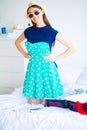 Vacation. Woman Who is Preparing for Rest. Young Beautiful Girl Sits on the Bed. Portrait of a Smiling Woman. Happy Girl Royalty Free Stock Photo