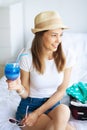 Vacation. Woman Who is Preparing for Rest. Young Beautiful Girl Sits on the Bed. Portrait of a Smiling Woman. Happy Girl Royalty Free Stock Photo