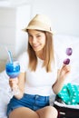 Vacation. Woman Who is Preparing for Rest. Young Beautiful Girl Sits on the Bed. Portrait of a Smiling Woman. Happy Girl Royalty Free Stock Photo