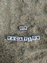 On vacation written on sand at the beach