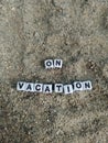 On vacation written on sand at the beach Royalty Free Stock Photo