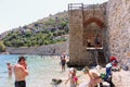 Vacationers bathe and sunbathe against the background of the ancient fortress wall Alanya, Turkey
