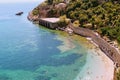 Vacationers bathe and sunbathe against the background of the ancient fortress wall Alanya, Turkey