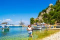 Vacationers enjoying transparent Ionian Sea waters Ithaca island Frikes port Greece Royalty Free Stock Photo