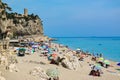 Vacationers on the free sandy and pebble Capo San Donato or Castelleto Pier Beach. Finale Ligure, Italy. Copy space