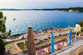 Vacationers on the free stony and terraced Brioni beach of the Adriatic Sea. Pula, Croatia