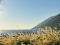 Vacationers on long Ionian sea with clear blue water. Summer holidays.