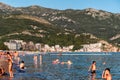Vacationers relaxing and swimming in the Adriatic sea in resort Becici in Montenegro