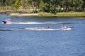 Vacationers ride boats and boats on the river.