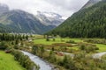 Vacationers stop with their vintage vehicle on the banks of the river that runs through the village of Solda, Ato Adige, Italy