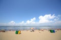 Vacationers sunbathe on the sandy