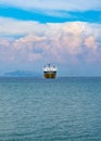 Greek ferry sailing in the Ionian Sea to the island of Kefalonia against the background of cumulus clouds Royalty Free Stock Photo