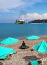 Vacationers tourists on the bench on the right tourist town of the Greek island of Kefalonia in Greece on the Ionian Sea coast in 