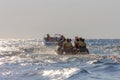 Vacationers tourists ride an inflatable banana in the sea