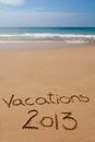 Vacations 2013 written in sand on tropical beach Royalty Free Stock Photo