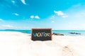 Vacations word in Blackboard on paradise tropical island beach with blue sky in summer for relaxation and vacations in Thailand Royalty Free Stock Photo