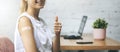 Vaccinated woman with plaster on shoulder showing thumb up in her work office. responsible action and vaccination concept. copy