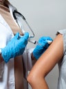 Vaccination. Doctor injecting flu vaccine to patient`s arm. Royalty Free Stock Photo