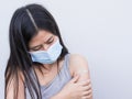 Vaccination, immunization disease prevention concept Woman in mask receives COVID-19 vaccine or the flu makes a painful face Royalty Free Stock Photo