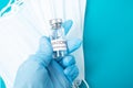 Vaccination of the population covid-19, delivery of a bottle of ampoule with coronavirus vaccine, Doctor`s hands in gloves hold a