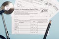 Vaccination record card. Vaccination form during the coronavirus epidemic on the medical table