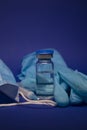 Vaccine bottle phial with no label, medical syringe with injection needle, blue medical mask and gloves . isolated on blue