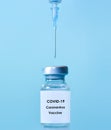 Vaccine in a bottle with a syringe on a blue background.The concept of medicine  healthcare and science.Coronavirus vaccine.Copy Royalty Free Stock Photo
