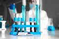 Vaccine corona glass with blur blood testing laboratory background Royalty Free Stock Photo