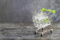 Vaccine in a grocery cart on a gray background