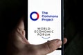 Vaccine passport app company logo displayed on a smartphone next to world economic forum logo.