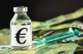 Vaccine price, cost or capital injection concept - glass vial and eur sign on pile of euro bank notes, green syringe near, black Royalty Free Stock Photo